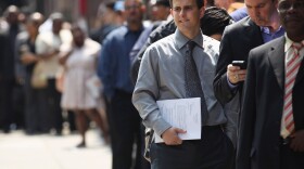Applicants wait to enter a job fair in New York City last month.