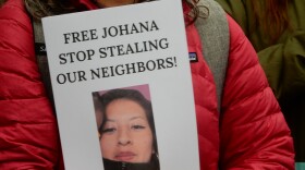 A person holds a sign during a Migrant Justice rally for detainees