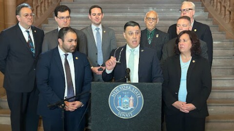 Sen. Anthony Palumbo, center, announces a complaint against Chief Judge Rowan Wilson on March 11, 2026.