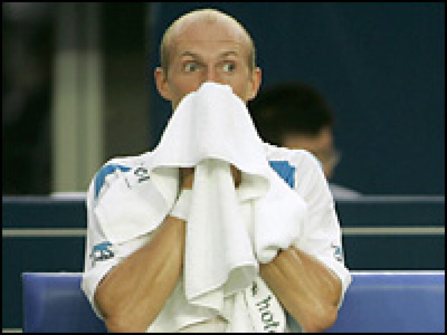 Nikolay Davydenko wipes his face during a match in the China Open Tennis Tournament, Sept. 13, 2007.