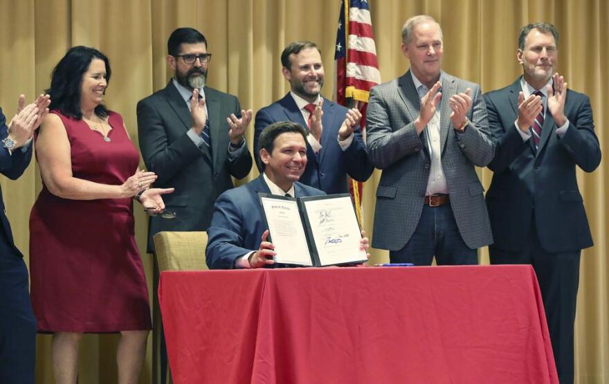  Florida Gov. Ron DeSantis smiles after signing a record $109.9 billion state budget Thursday, June, 2, 2022 at The Villages, Fla. Florida Gov. Ron DeSantis on Thursday signed a $109.9 billion state budget bill that includes pay raises for state workers and law enforcement, as well as tax suspensions on gas, diapers and school supplies. 