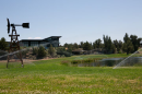 Sprinklers keep the grass green in the landscaping surrounding a pond and a pool at a property in Central Oregon