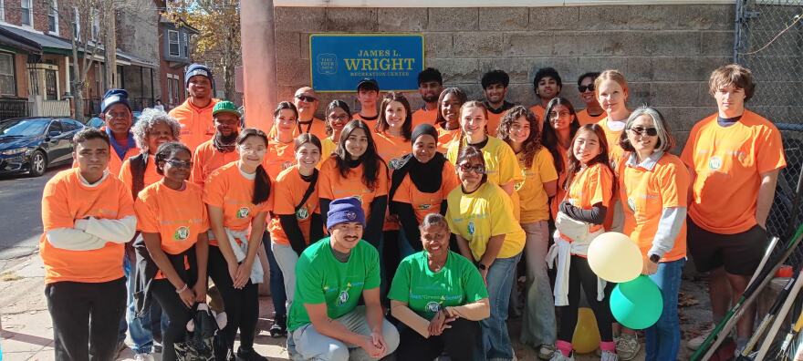 Gweny Love poses with volunteers from a neighborhood cleanup