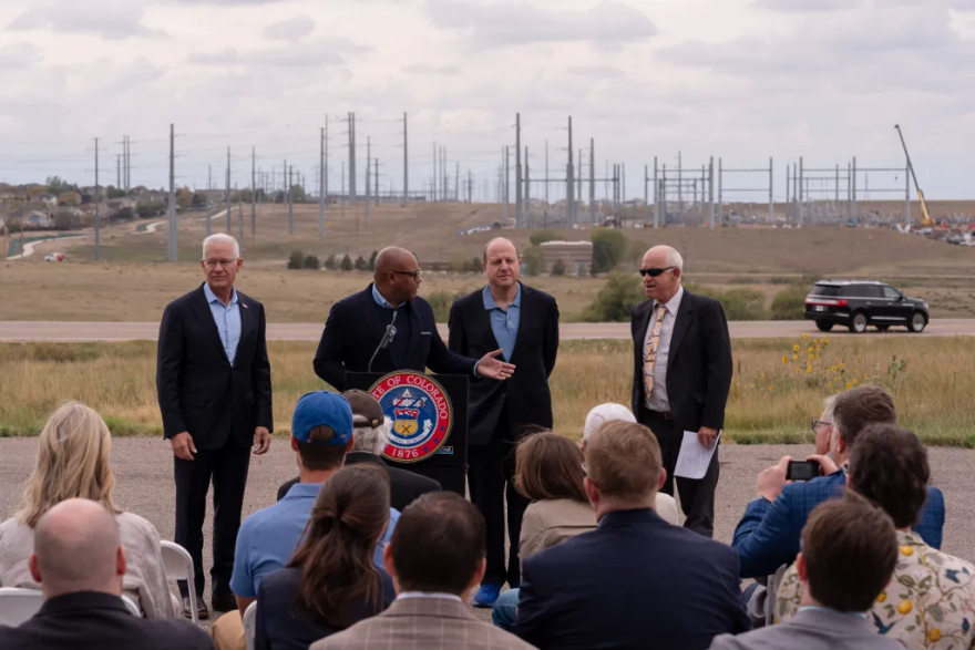 From left to right, U.S. Department of Energy Assistant Secretary for the Office of Environmental Management Timothy J. Walsh, Xcel Energy President Robert Kenney, Gov. Jared Polis and Colorado Energy Office Executive Director Will Toor attend a press conference on Thursday, Sept. 24, 2026, in Aurora. The Department of Energy announced a $250 million federal award to fund upgrades to Colorado’s electricity grid, increasing transmission capacity and helping meet the state’s growing demand for power.