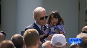 President Biden holds 2-year-old Mancuaq Mann, of Dillingham, Alaska. Her mom, Alannah Hurley, says Mancuaq held up well at the White House event despite missing nap time. (C-SPAN screenshot)