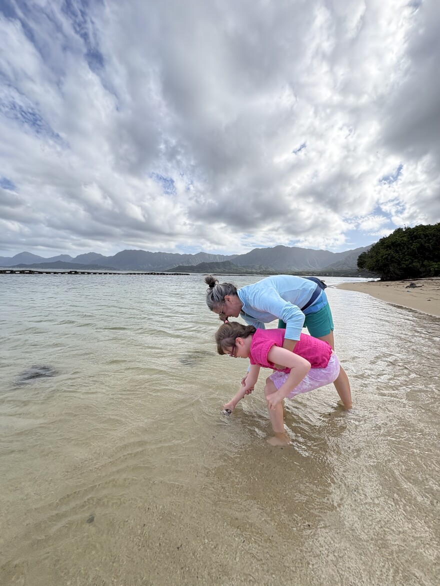 Mom Courtney and daughter, Maddie, collect samples together at Kualoa Beach on Oʻahu.