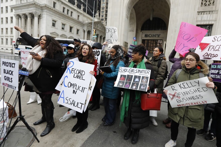 Sonja Spoo, left, associate campaign director of Ultra Violet, leads chants during an R. Kelly protest outside Sony headquarters, in New York, Wednesday, Jan. 16, 2019.  Kelly has been under fire since the recent airing of a Lifetime documentary "Surviving R. Kelly ." He has denied all allegations of sexual misconduct involving women and underage girls. (Richard Drew/AP)