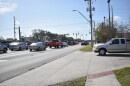 Cars in line at a red stoplight.