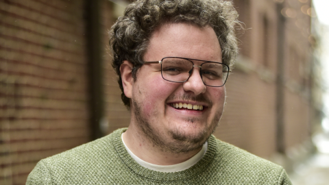 Andrew Henderson standing in an alley.