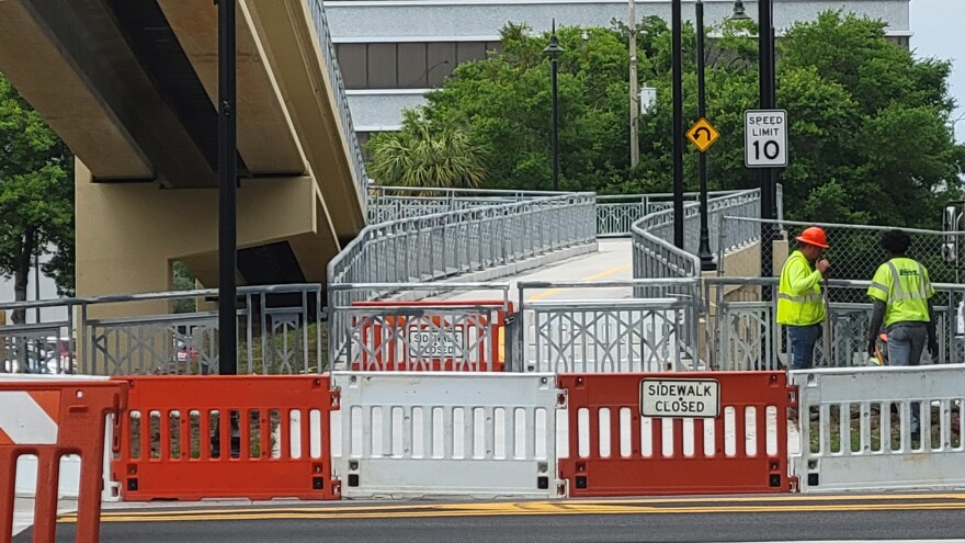 Workers were addressing some final details Monday at the Riverside end of the new shared use path next to the Fuller Warren Bridge.