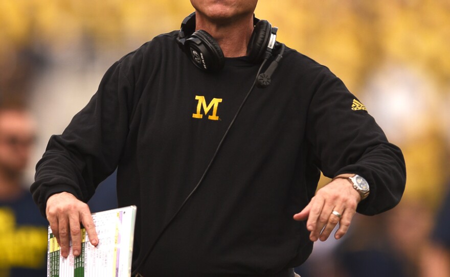 Michigan coach Jim Harbaugh motions to an offical after seeing his team penalized for a play in the first half. (Greenberry Taylor/ WUFT News)