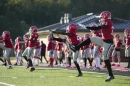 Football players from a Mississippi high school warm up before practice. There are new recommendations to get big linemen safe during hot weather workouts.