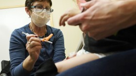 Deborah Sampson, left, a nurse at a University of Washington Medical Center clinic in Seattle, gives a Pfizer COVID-19 vaccine shot to a 20-month-old child, June 21, 2022, in Seattle. The U.S. on Thursday, Dec. 8, 2022 open doses of the updated COVID-19 vaccines for most children younger than age 5. The Food and Drug Administration's decision aims to better protect the littlest kids from severe COVID-19 at a time when children’s hospitals already are packed with tots suffering a variety of other respiratory illnesses, too. (AP Photo/Ted S. Warren, file)