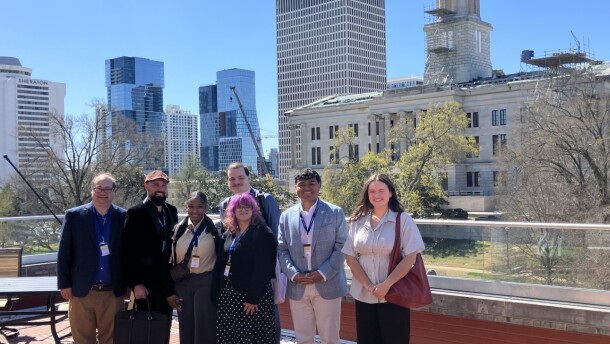 Josh Azriel - with students Jonathan Walker, Yahinness Lum, Grace Steele, Brandon Denley (behind Grace), Zach Lewis and Kayelyn McCaslin - standing in front of the Tennessee State Capitol at the Cordell Hull State Office Building.