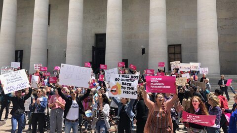 Abortion supporters gather outside the Ohio Statehouse on Tuesday to rally against the anti-abortion laws in the state.