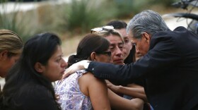 The Archbishop of San Antonio, Gustavo Garcia Seller, comforts families outside of the Civic Center following a deadly school shooting at Robb Elementary School in Uvalde, Texas Tuesday, May 24, 2022. (AP Photo/Dario Lopez-Mills)