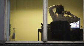 A city office employee works into the night as darkness closes in on October 10, 2005 in Glasgow, Scotland. (Christopher Furlong/Getty Images)