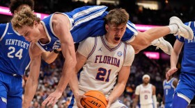Kentucky guard Collin Chandler (5) falls onto Florida forward Alex Condon (21) during the second half of an NCAA college basketball game in the quarterfinal round of the Southeastern Conference tournament, Friday, March 13, 2026, in Nashville, Tenn. (AP Photo/George Walker IV)