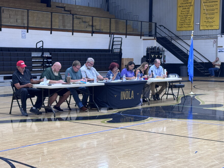 Inola Town Council addresses a crowd at the local high school gymnasium, many of whom oppose a smelter project planned for their community.