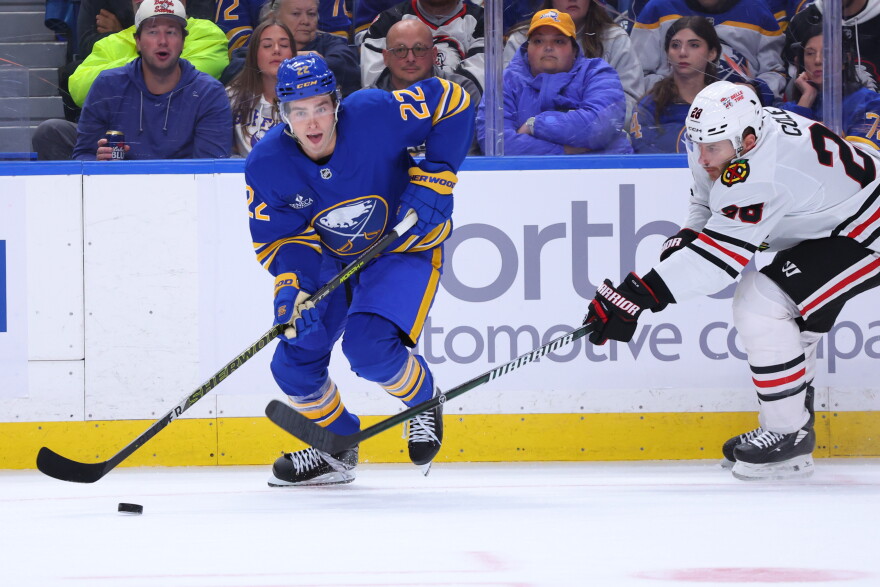 Buffalo Sabres right wing Jack Quinn (22) carries the pick past Chicago Blackhawks defenseman Ian Cole, right, during the first period of an NHL hockey game Saturday, Oct. 3, 2026, in Buffalo, N.Y. (AP Photo/Jeffrey T. Barnes)