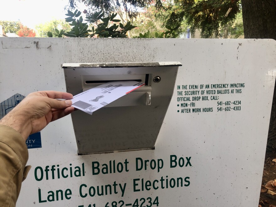 An Oregon voter makes use of one of many official ballot drop boxes across Lane County.