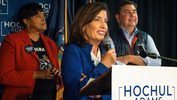 Governor Kathy Hochul speaks to a crowd, with U.S. Rep. John Mannion (NY-22) and Syracuse Mayor Sharon Owens behind her. 