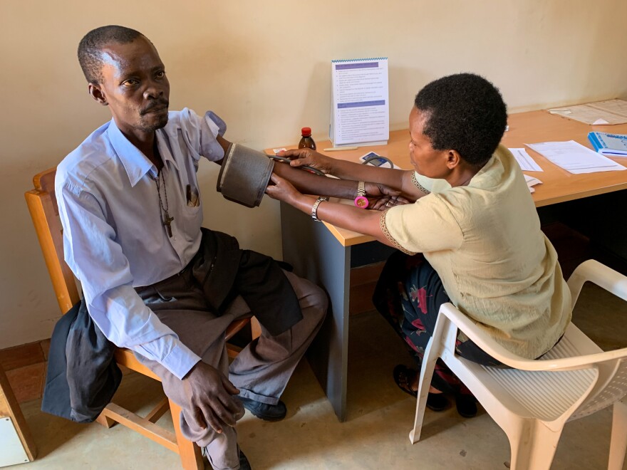 Noah Nsonzi gets a checkup at Hospice Africa. Nsonzi has pancreatitis. Nurses have prescribed liquid morphine to deal with resulting pain. The founder of the organization, Anne Merriman (not pictured), was a driving force behind Uganda's system for using liquid morphine.