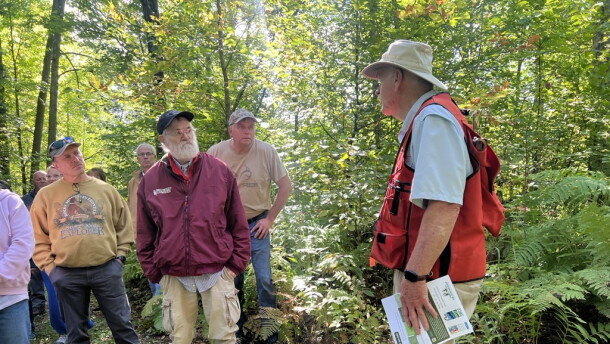 Gary Anderson speaks to a crowd touring his property Sept. 12 near Outing. 