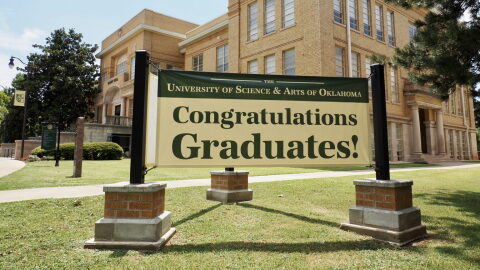 A sign outside of Troutt Hall on the University of Science and Arts of Oklahoma campus congratulates graduates on July 10, 2024, in Chickasha.