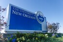 Flowers grow on Thursday, Dec. 15, 2022, in front of the University of New Orleans sign on Lakeshore Drive in New Orleans, La.