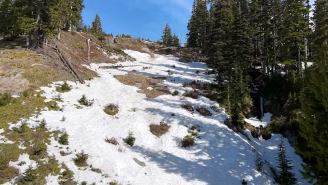 A mountain top with scant snow.