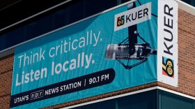 A KUER banner hangs outside the Eccles Broadcast Center at the University of Utah in Salt Lake City, Jan. 16, 2025. KUER and PBS Utah announced a 10% cut to their collective workforce after Congress voted last July to rescind $1.1 billion of federal funding for public media.