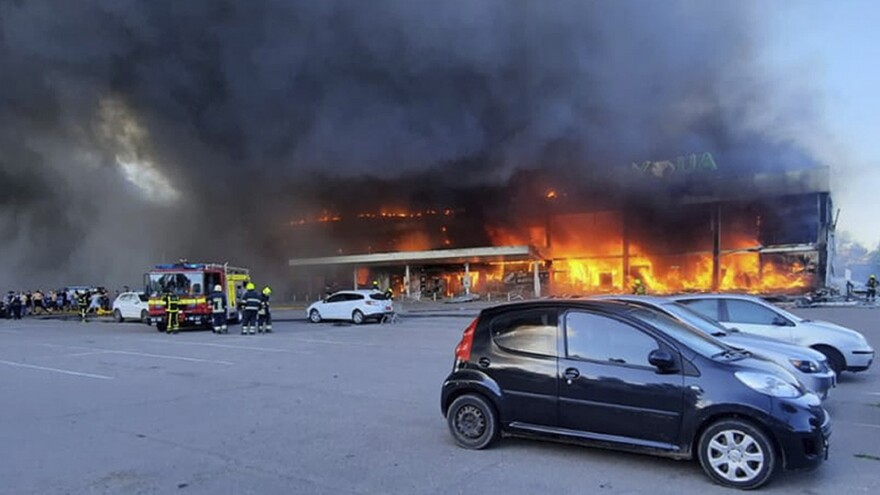 In this image made from video provided by Ukrainian State Emergency Service, firefighters work to extinguish a fire at a shopping center burned after a rocket attack in Kremenchuk, Ukraine, on Monday.