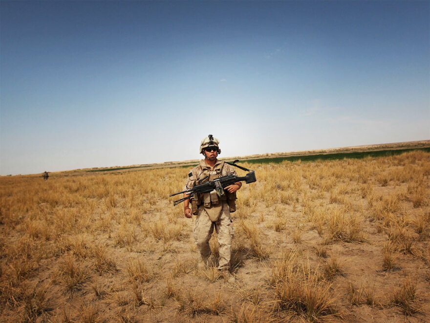 U.S. Marine Lance Cpl. Josh Yang marches through rural scrubland near Khan Neshin in Helmand Province, Afghanistan, in March. Defense Secretary Robert Gates says the Marine Corps has gotten away from its "maritime soul" while working in the desert.