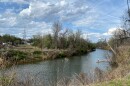 A man fishes in the Rivanna River just south of Free Bridge and near where small clusters of tents house people experiencing homelessness, three-quarters of whom are locals, according to the Blue Ridge Area Coalition for the Homeless.