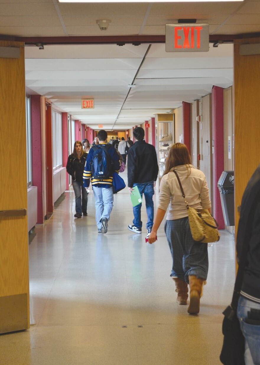 Students walk the halls at Monroe Community College. Every year, Monroe County taxpayers pay millions for county residents to attend community college outside the county.