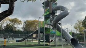 Image of an enclosed gray tube slide at a playground
