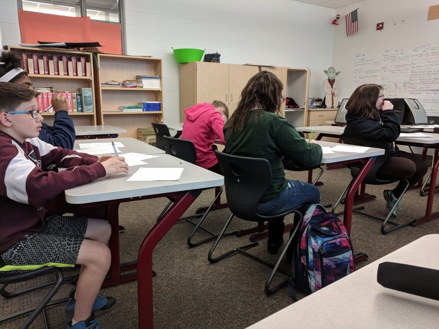 Students at desks writing