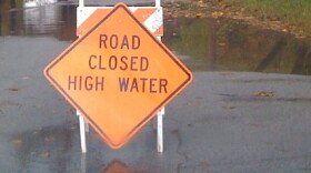 Numerous roads, like this one in Bixby, were closed by swift rising water.