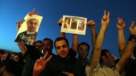 Iranians celebrate the victory of moderate presidential candidate Hasan Rowhani (portrait) at Vanak square in northern Tehran on Saturday.