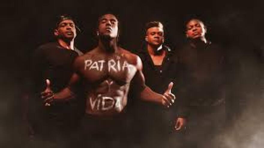 Cuba rapper Yotuel Romero (center) and other Cuban singers in the music video for Patria y Vida