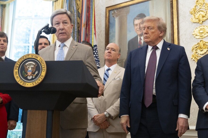 Rep. Mike Rogers, R-Ala., speaks as President Donald Trump listens in the Oval Office at the White House, Tuesday, Sept. 2, 2025, in Washington. (AP Photo/Mark Schiefelbein)