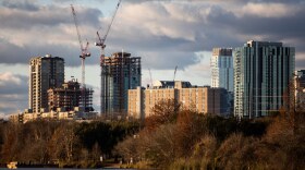 Construction cranes on the downtown Austin city skyline as seen from Lady Bird Lake on Jan. 11, 2021.