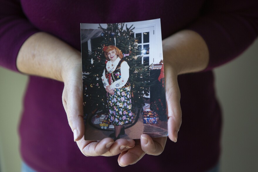 Dorothy Cassaro holds a photograph of her mother, Annette. "My mom died among strangers," she said.