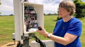 Climatologist Pam Knox with a weather station.