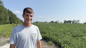 Farmer Joe Lau stands in front of his field of soybeans in St. Joseph, Mo. Lau says earlier springs have not affected his production negatively but he worries about pests on his crops.