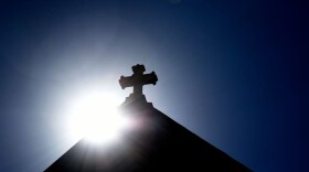 SANTA FE, NEW MEXICO - JUNE 21, 2020:  The sun rises behind a stone cross atop the historic Cathedral Basilica of St. Frances of Assisi in Santa Fe, New Mexico. (Photo by Robert Alexander/Getty Images)