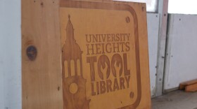 A piece of wood that has the engraving of "University Heights Tool Library".