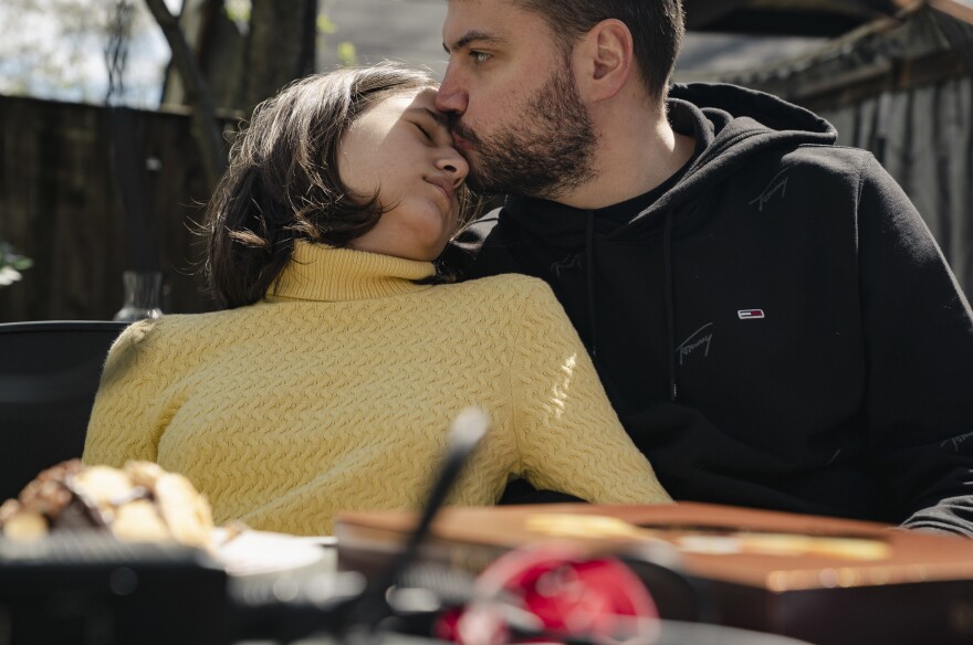 Artem Koliubaiev kisses Amira on her forehead after more than a month of separation. Koliubaiev could stay in the United States for just a short time but flew in to surprise the family.