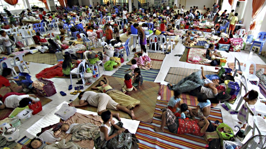 Hundreds of residents take shelter Friday inside the provincial capitol of Surigao city close to central Philippines in anticipation of typhoon Hagupit which is expected to hit land Saturday afternoon. About a year ago the country was lashed by Typhoon Haiyan, which left more than 7,300 people dead.